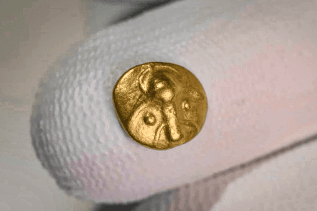 La pièce de collection : ce qui fait sa valeur et comment la garder 3 Pièce d'or celtique ancienne tenue par un gant blanc, geste de base pour manipuler une pièce de collection