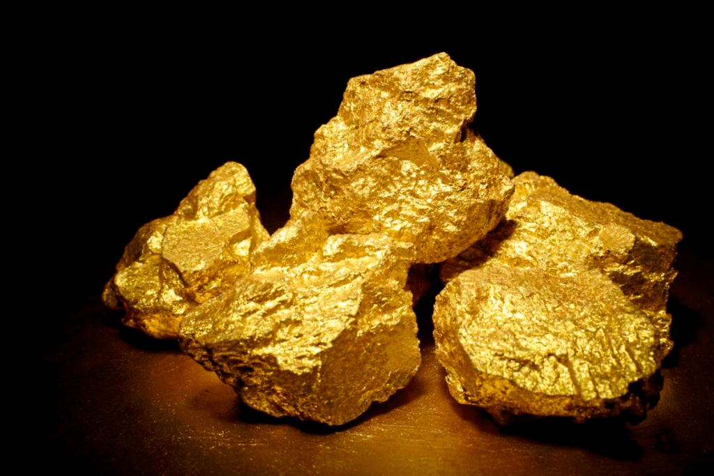 L'or d'investissement : définition légale et exonération de TVA 5 Pépites d'or sur fond noir